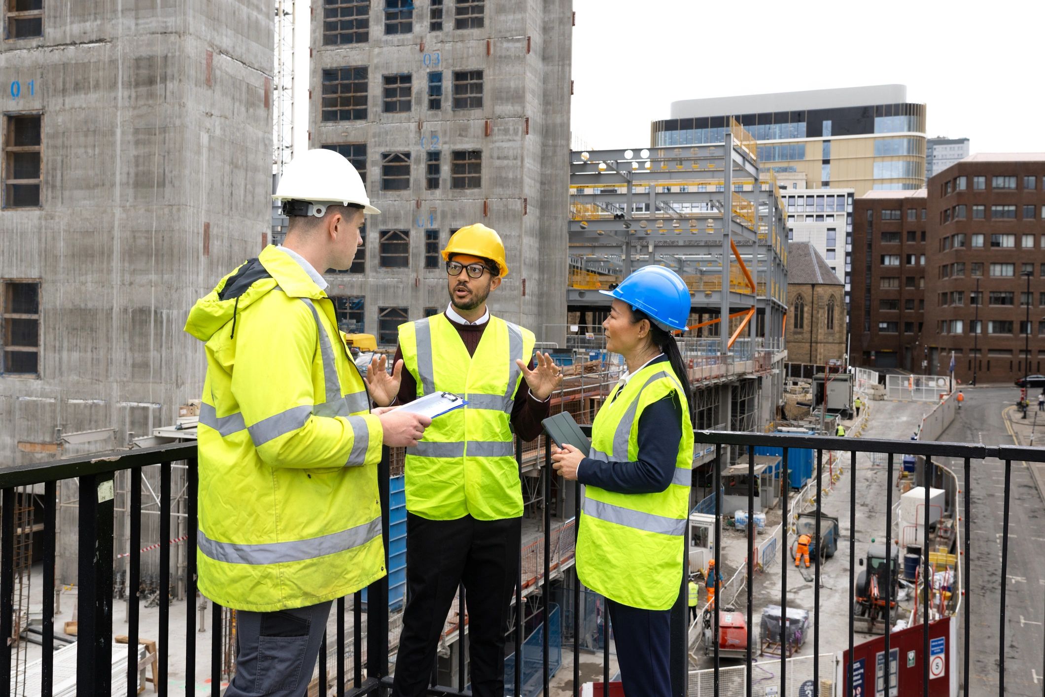 Industrial team reviewing plans on site